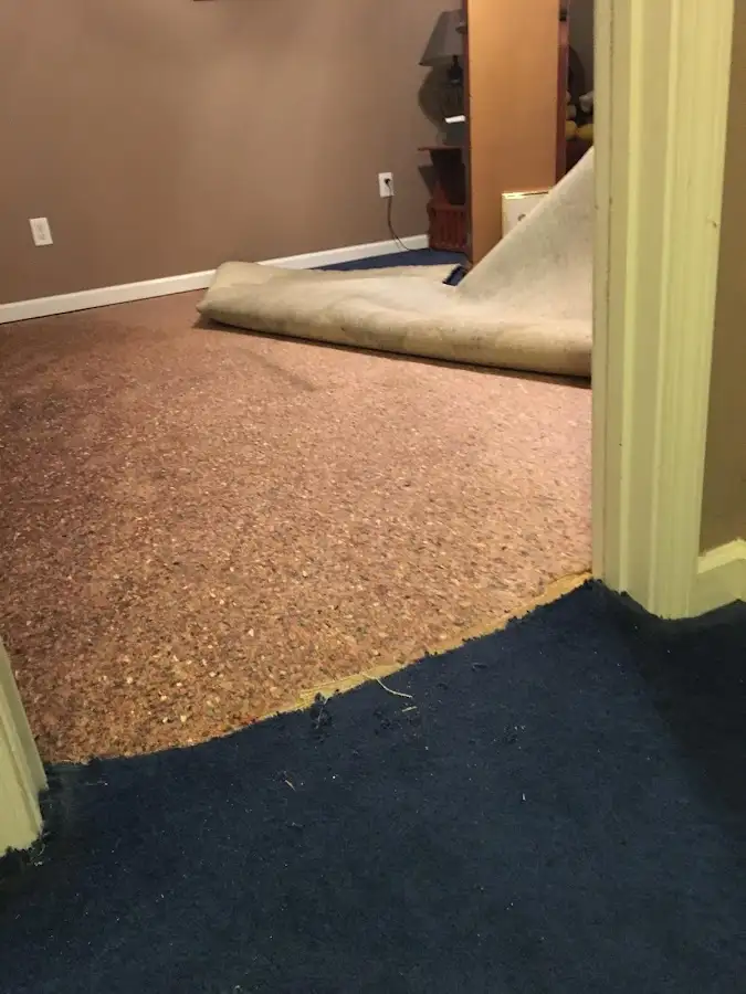 Carpet pad removal revealing water damage during Drying & Dehumidification in Brookings